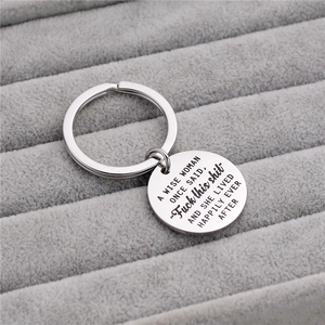 Inspirational stainless steel keychain with humorous quote on a gray velvet display box