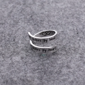 Bague spirale argentée avec symboles de cœur et gravure d'amitié sur feutre gris