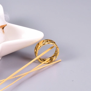 Macro detail of a wide hollow chain link ring in 18K gold plated stainless steel