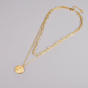 Close-up of 18k gold double layer necklace with an angel relief pendant and lobster clasp