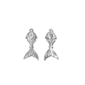 Polished silver stainless steel fishtail charms with intricate scale details on white background