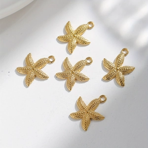 Macro view of five gold starfish pendants with textured surface for DIY jewelry making