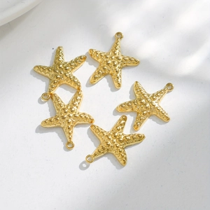 Detailed view of five gold-plated starfish charms with textured surface for DIY jewelry