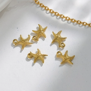 Five golden stainless steel starfish charms for jewelry making with polished radial texture