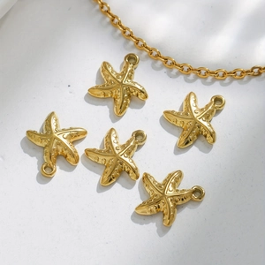 Detailed macro view of gold plated starfish pendants with textured finish and matching chain