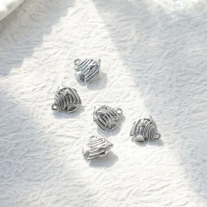 Detailed view of five polished tropical fish pendants for DIY jewelry crafting