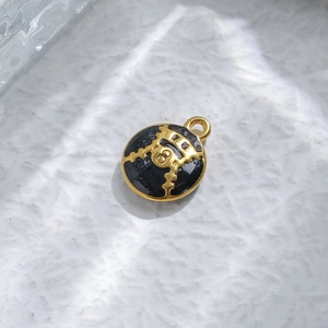 Vintage round stainless steel drop earrings with black enamel and gold mapping patterns