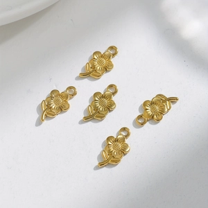 Detailed view of gold stainless steel sunflower charms for DIY jewelry making and crafts