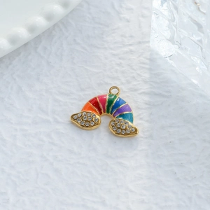 Colorful rainbow pendant with gold base and sparkling crystals on white background