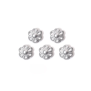 Detailed view of five silver flower-shaped metal beads for DIY jewelry making and crafts