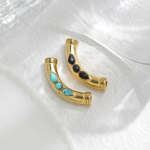 Detail of gold metal beads with teardrop turquoise and black agate stones for DIY jewelry