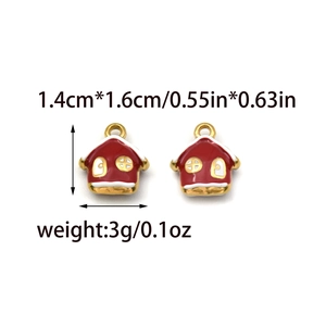 Macro detail of red house heart pendant charms with gold bail and enamel finish