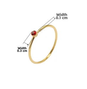 Detailansicht eines schmalen 18K vergoldeten Titanstahlrings mit rotem Edelsteinbesatz