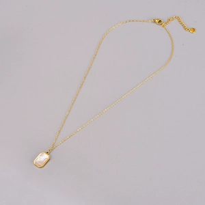 Elegant gold chain necklace featuring a rectangular shell pendant with adjustable extension