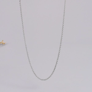 Detailed macro shot of minimalist silver pearl choker chain with delicate round ring links
