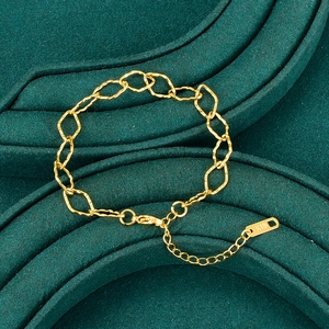 Minimalist K18 gold rhombus link chain bracelet displayed on green velvet jewelry box