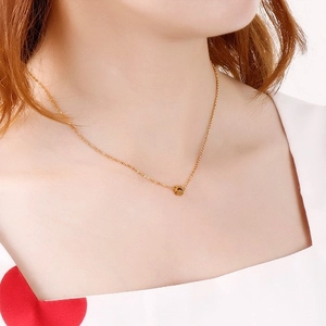 Minimalist golden stainless steel necklace with delicate star pendant on female model