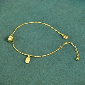 18K gold-plated anklet with gourd charm and fortune pendant on green background