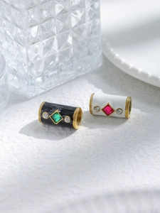 Macro shot of cylinder enamel beads with square gemstones and rhinestones for jewelry DIY
