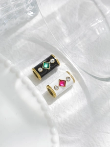 Macro detail of enamel cylinder beads with square crystals and pavé diamonds for DIY jewelry