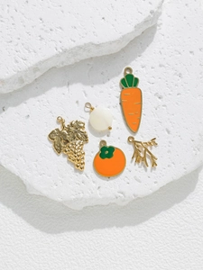 Detailed view of DIY fruit and plant pendants including carrot, grape, and branch charms