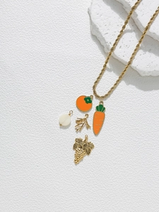 Detailed close-up of a gold rope chain necklace featuring five creative enamel fruit charms