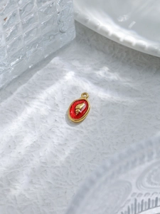 Detail of 18K gold plated ocean series shell pendant with red enamel finish for jewelry making