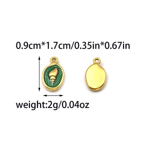 Detail of 18K gold plated oval pendants with green enamel and sea shell relief pattern