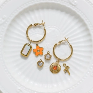Golden stainless steel earring hoop set with interchangeable star heart and floral charms