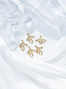 Detailed view of five gold coral-shaped branch pendants for DIY jewelry making