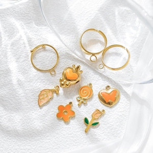 DIY jewelry set with gold rings and orange enamel heart flower lollipop leaf pendants