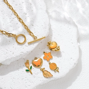 Golden stainless steel jewelry set with orange enamel flower and heart pendants