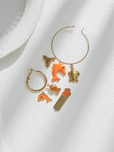 Golden ocean charms set featuring dolphins, sea turtles, and shells on white background