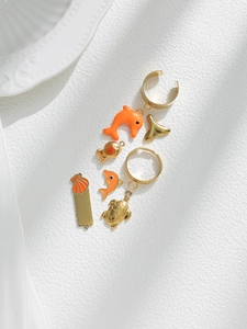 Detailed macro shot of marine life charms including dolphins and turtles for DIY jewelry