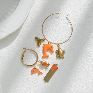 Golden ocean jewelry set with enamel dolphin, turtle, whale tail and shell charms