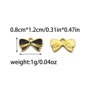 Detail view of small stainless steel bow pendants with size metrics and weight