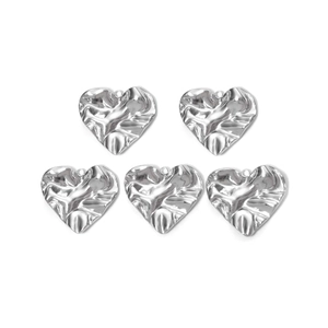 Detailed view of silver heart charms with unique hammered texture and attachment rings