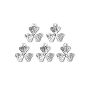 Detailed view of 5-piece clover shaped silver metal charms with radial pattern for DIY jewelry