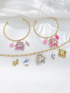 Detailed view of floral enamel pendants and gold stainless steel jewelry components