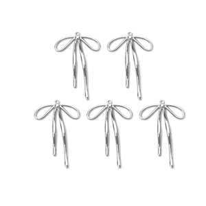 Macro view of five silver polished ribbon bow charms with integrated top hanging loops