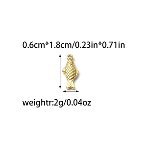 Close-up of golden fish pendant with detailed scale texture and size dimensions