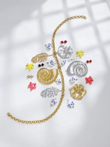 Flat lay of 18K gold plated stainless steel starfish and seashell jewelry DIY charms