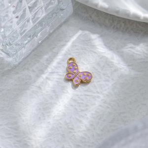 Detail of purple enamel butterfly pendant with gold plating for DIY jewelry