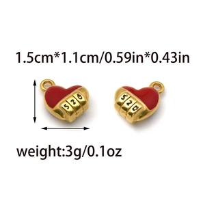 Detail view of a 1.5cm red enamel heart pendant with 520 engraving in 18K gold finish