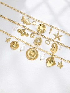 Detailed view of 18K gold plated stainless steel starfish and gingko leaf jewelry charms