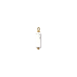 Macro detail of rectangle white marble pendant with golden beads and a secure hanging ring