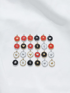 Macro view of 24 colorful enamel stainless steel charms with star heart and lightning patterns