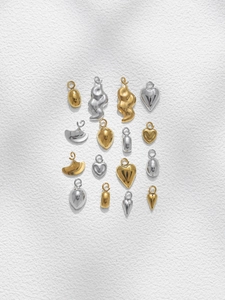 Variety of gold and silver geometric charms in a 4x4 matrix for DIY jewelry making