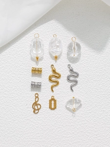 Close-up of DIY jewelry set with stainless steel snake charms and clear beads