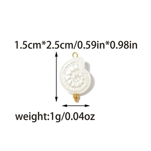Detail of seashell charm with pearl texture, gold bail and dimensions of 1.5cm by 2.5cm